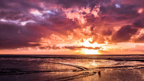 Scenic view of beach against sky during sunset