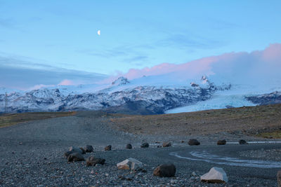 Scenic view of snow covered land against sky