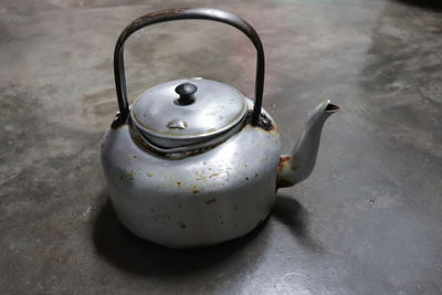 High angle view of old kettle on table