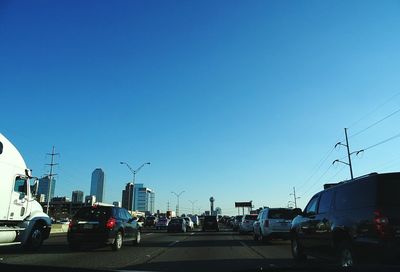 Cars on road against clear sky