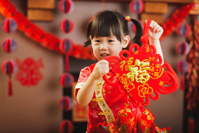 Portrait of cute girl in red shop