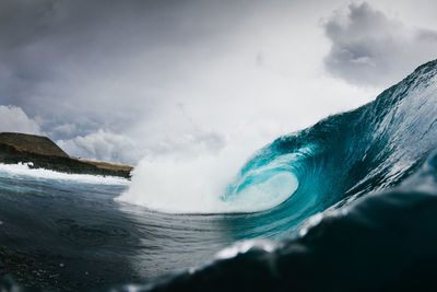 Scenic view of sea waves against sky