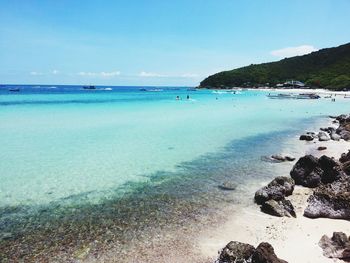 Scenic view of beach against blue sky