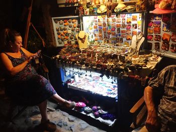 Woman sitting at market stall