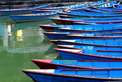 Stack of boats moored in lake