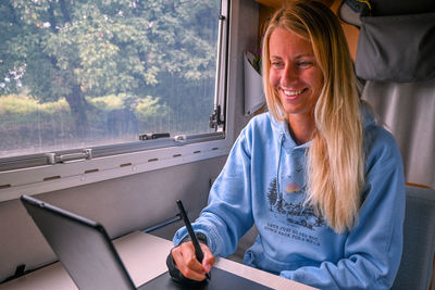 Portrait of young woman using mobile phone