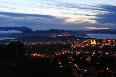 Aerial view of illuminated cityscape against sky at night