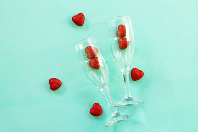 High angle view of berries on table against blue background