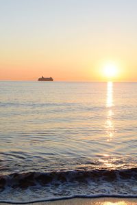 Scenic view of sea against orange sky