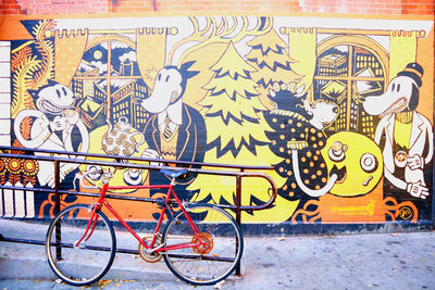 Graffiti on bicycle against wall