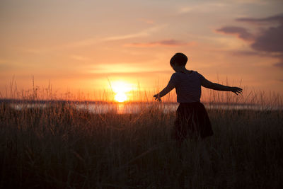 Silhouette of woman at sunset