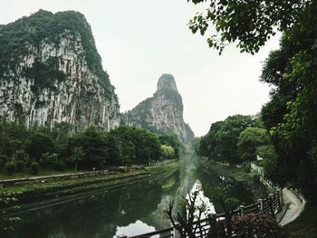 Scenic view of rocks and trees against sky