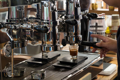 Cropped image of barista making coffee in cafe