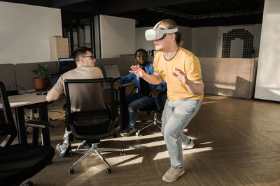 It development team working on vr project. man wearing vr headset, touching something in the virtual