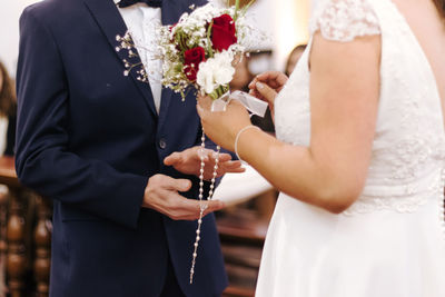 Midsection of woman holding flower bouquet