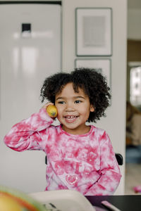 Portrait of cute girl playing with toys at home