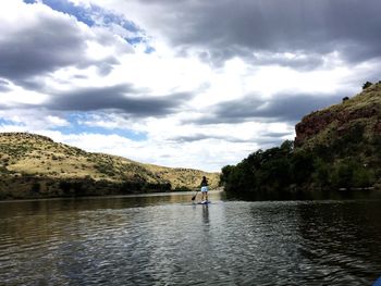 Scenic view of calm lake against cloudy sky