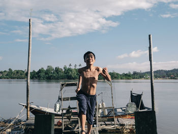 Portrait of young man running away from a boat