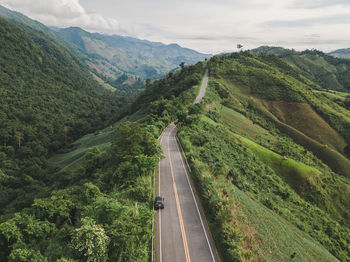 High angle view of road amidst mountains against sky