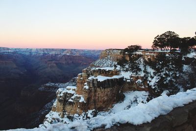 View of snow covered landscape during sunset