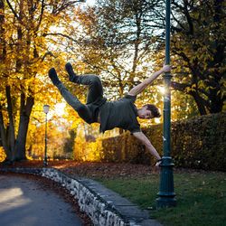 Full length of man hanging on pole during autumn