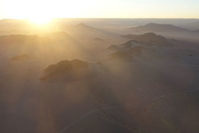 Scenic view of desert against sky during sunset