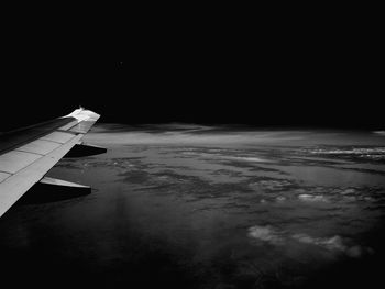 Airplane flying over sea against sky