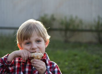 Portrait of boy eating food