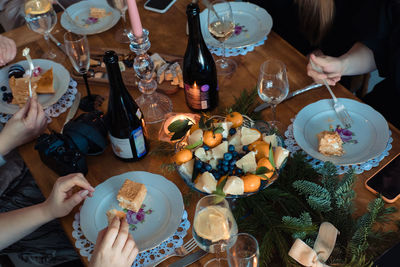 Christmas dinner with tangerines, candles and spruce branches for decoration