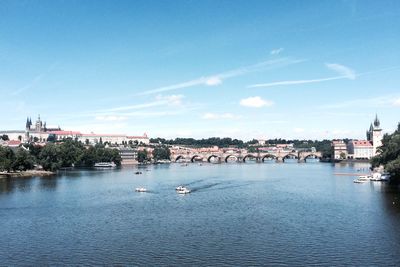 Boats in river with buildings in background