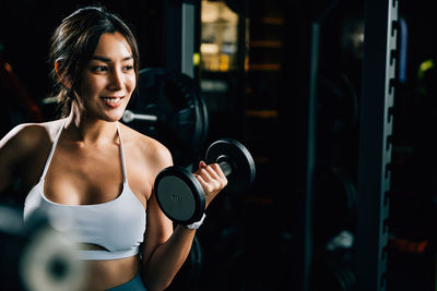 Young woman exercising in gym