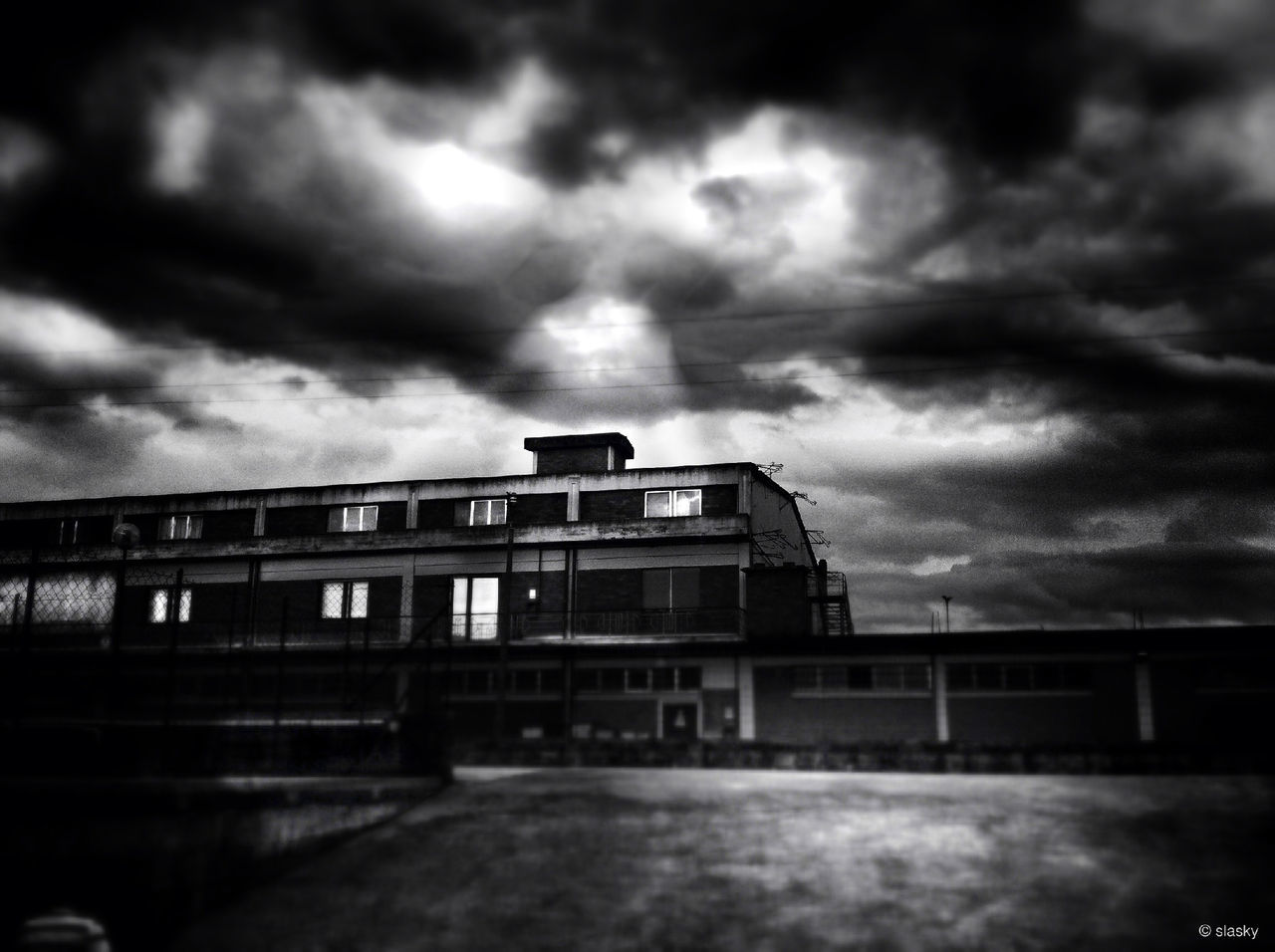 architecture, sky, cloud - sky, cloudy, built structure, building exterior, weather, overcast, storm cloud, cloud, low angle view, dusk, dramatic sky, building, railing, outdoors, no people, atmospheric mood, city, day