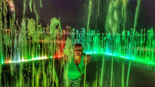 Portrait of smiling woman standing in water