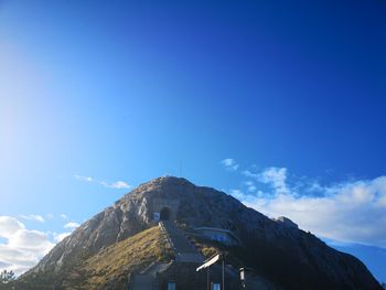 Low angle view of mountain against blue sky