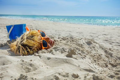 Rear view of woman relaxing at beach