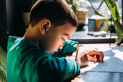 Portrait of cute boy holding table