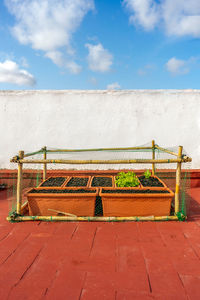 Empty bench against sky