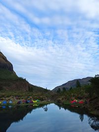 Scenic view of lake and mountains against sky