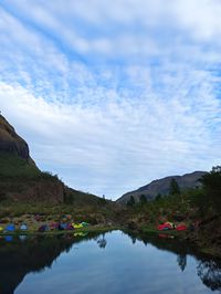 Scenic view of lake and mountains against sky