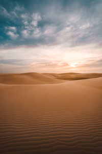 Scenic view of desert against sky during sunset