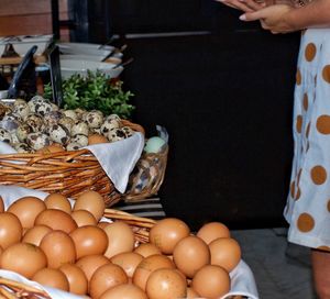 Midsection of person with vegetables in market stall