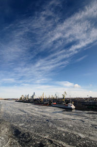 Cranes at construction site against sky