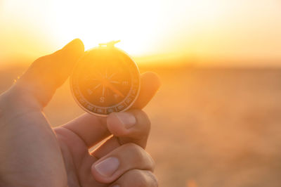 Close-up of hand holding orange