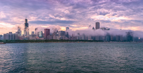Scenic view of buildings against sky during sunset