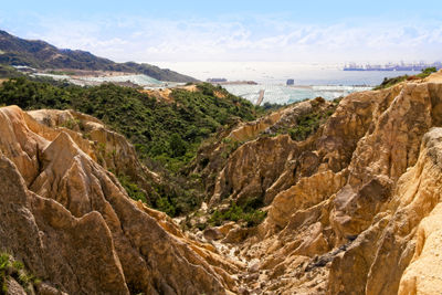 Scenic view of sea and mountains against sky