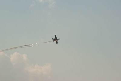 Low angle view of airplane flying in sky