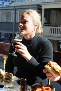 Young woman holding ice cream in restaurant