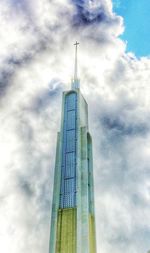 Low angle view of tower against cloudy sky