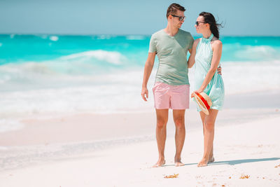 Full length of woman standing on beach