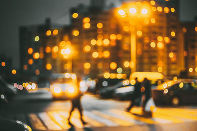 Defocused image of illuminated city at night